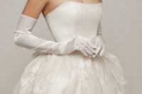 classic white satin gloves accent the modern wedding ballgown and give a refined touch to the outfit