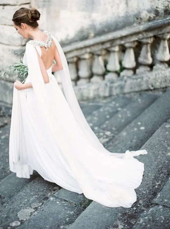 elegant open back wedding gown with an embellished cape veil to make it stand out