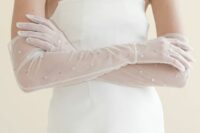 sheer wedding gloves with rhinestones are a cool idea for a modern bride who wants a touch of glam