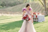 02 a blush A-line wedding dress with a train and a fuchsia shoulder accent of wispy feathers create a lovely bridal look
