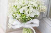 03 a beautiful and romantic white wedding bouquet of lily of the valley and large blooms with a ribbon bow is amazing