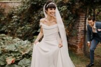 03 a beautiful off the shoulder A-line wedding dress with a draped bodice and a plain skirt with a train is a lovely idea for a wedding