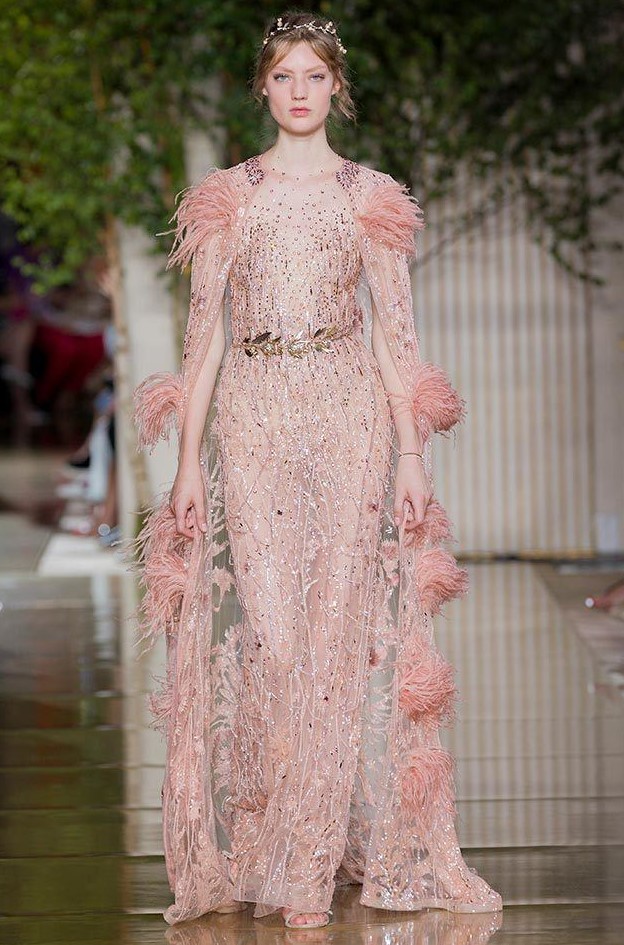 a bold pink sheer embellished wedding dress paired with a matching sheer embellished feather capelet create a royal look