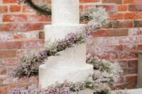 05 a neutral textural wedding cake with a fantastic blooming swirl around it to make its look ultimate and sophisticated