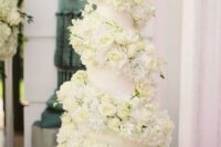 06 a neutral wedding cake with an oversized white rose swirl around it is a very chic and cool idea for a refined neutral wedding