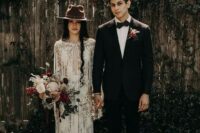 07 a boho lace sheath wedding gown with a plunging neckline, a train and long fringe plus a brown hat