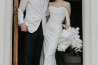 08 a classy modern and sophisticated wedding dress with a draped bodice and statement earrings for an ultimate look
