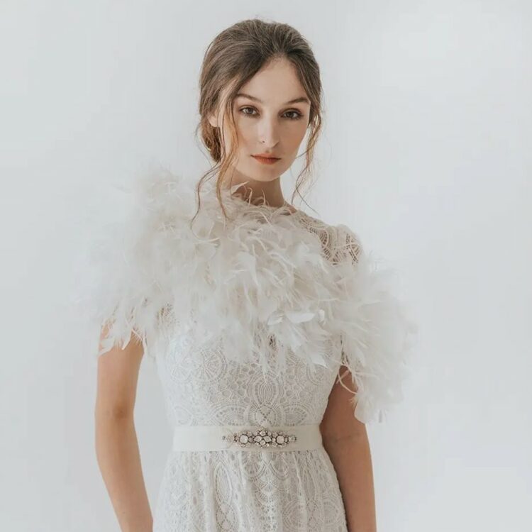 a feather bridal stole looks like part of the wedding dress, it's a chic way to incorporate feathers into your bridal look