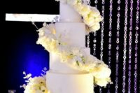 08 a white round wedding cake with white rose swirls around it is a very beautiful and bold idea for a formal wedding
