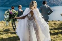 10 a glam bridal look with a floral applique wedding dress with a draped skirt and a feather cover up that brings an ultimate touch
