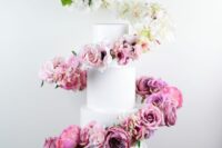 12 a white wedding cake with an ombre flower swirl around it, from white to bold fuchsia, is a fantastic idea to rock