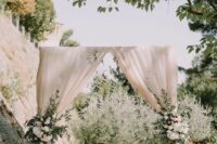 13 a classic wedding backdrop of neutral drapes, white blooms and greenery is a lovely idea for many wedding styles