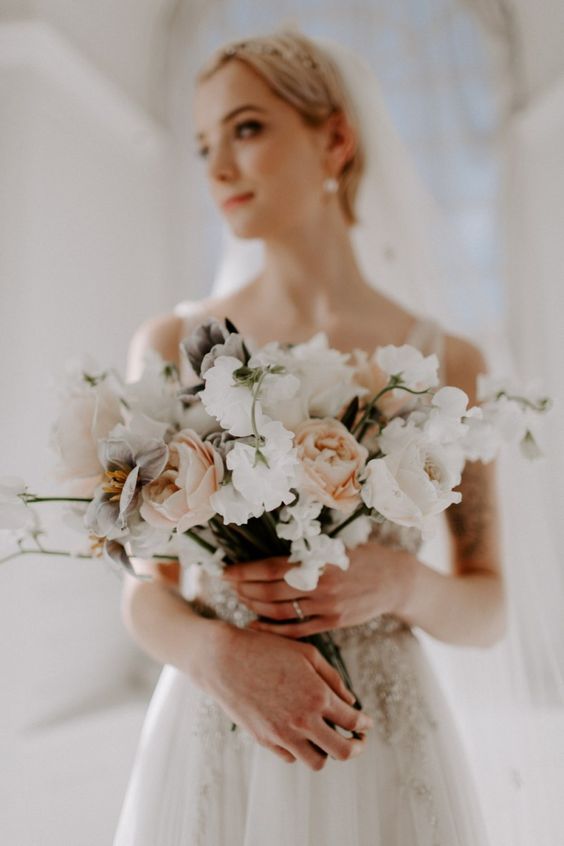 a lovely modern wedding bouquet with peachy, blush and white blooms is a lovely idea for a spring or summer wedding