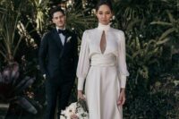 13 a modern A-line midi wedding dress with a turtleneck, draped sleeves and a waistline, white shoes are a lovely modern bridal look