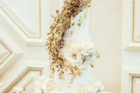 13 a white wedding cake with gold foil, with a gold leaf swirl and white sugar and fresh blooms i s a refined idea for a wedding