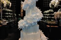14 a beautiful textural white wedding cake with white sugar flower swirls around it is a very sophisticated and chic idea