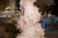 15 a blush wedding cake with blush and pink sugar bloom swirls around it is a very chic and cool idea for a pastel wedding