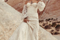 15 a gorgeous western bridal look with a strapless boho lace A-line wedding dress and bell sleeves, creamy embellished boots, a grey hat and statement accessories