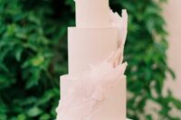 16 a blush wedding cake with matching sugar swirls around is a very chic and delicate idea for a pastel wedding