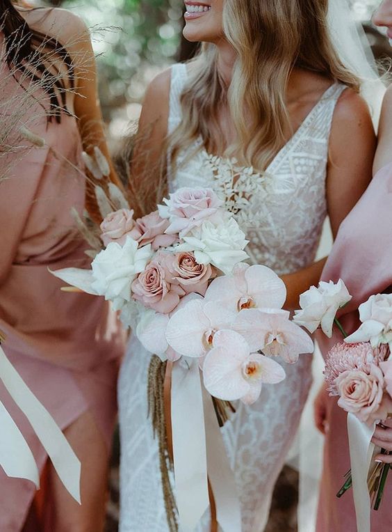 an elegant modern wedding bouquet of blush and white roses, blush orchids and bunny tails is a lovely idea