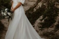 17 a modern wedding ballgown with a draped bodice and a square neckline, puff sleeves, a long veil and a long train for a romantic look