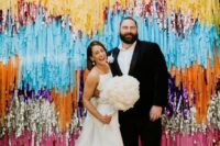 17 a super colorful and tinsel streamer wedding backdrop is a gorgeous idea for a fun and maybe disco-themed wedding