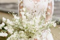 17 an all-white wedding bouquet of blooming branches is a heavenly beautiful idea for a spring bride