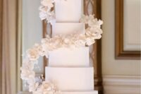 18 a large white square wedding cake with spiral white sugar blooms is a gorgeous idea for a refined modern wedding