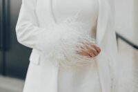 18 a minimalist bridal ensemble with a plain strapless mini wedding dress, a matching blazer with feather sleeves