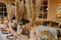 19 a bright and catchy western wedding tablescape with pampas grass, fronds, neutral and fall-colored blooms, lights, rust napkins