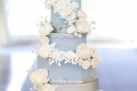 20 a refined dusty blue wedding cake with white sugar bloom swirls and touches of silver plus monograms is amazing