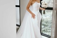 20 a refined modern wedding ballgown with a draped bodice and multi-layered skirt with a train is a very chic idea