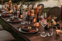 21 a bright western wedding tablescape with bright blooms and dried grasses, orange candles, black and grey plates and smaller candles