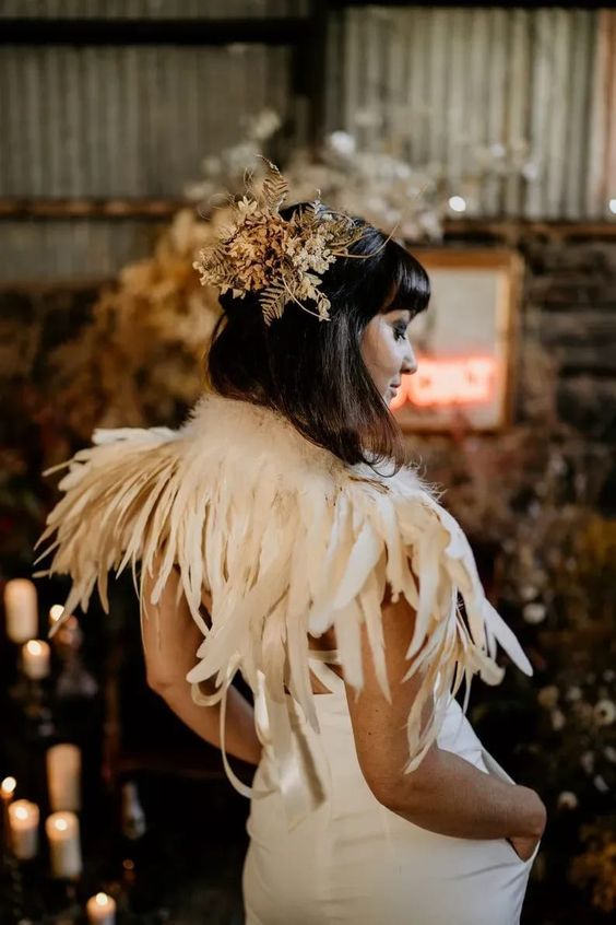 a small yet bold feather wedding cover up will become part of your wedding dress and will make your look fairy tale inspired