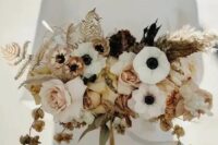 22 a stylish modern wedding bouquet of white anemones, blush and rust roses, dried blooms, leaves and grasses and mustard ribbons