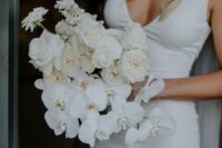 24 a simple and modern white wedding bouquet of orchids and roses is a stylish idea for an all-white wedding