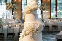 24 a white round wedding cake with white flower swirls around it is a very chic and beautiful idea, with a spectacular touch