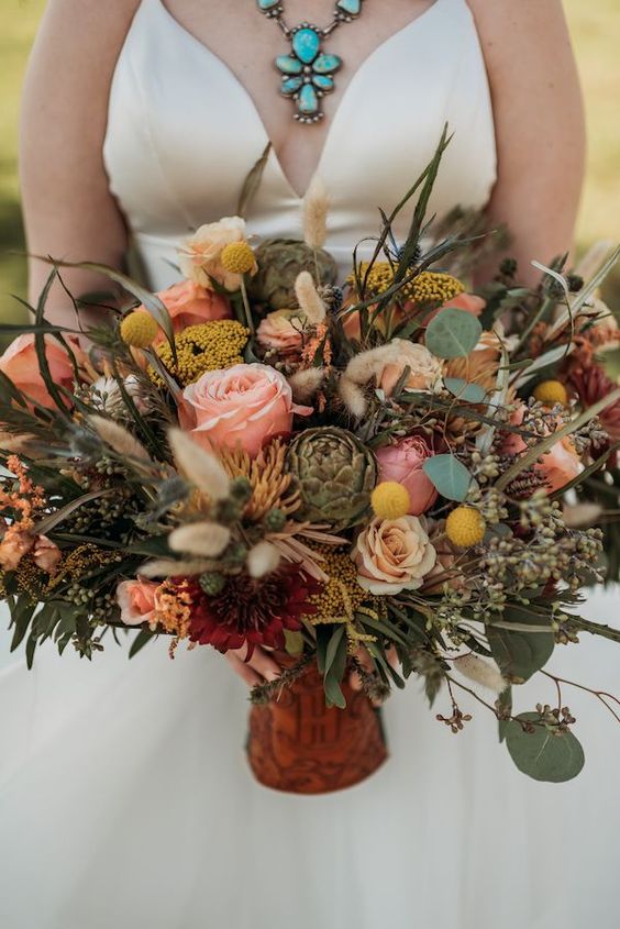 a western wedding bouquet of pink and blush blooms, billy balls, greenery, thistles and succulents is a jaw-dropping idea