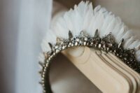 27 a catchy embellished wedding tiara with pearls, embellishments and white feathers is a fantastic idea for a bride