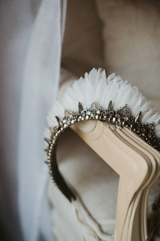 a catchy embellished wedding tiara with pearls, embellishments and white feathers is a fantastic idea for a bride