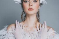 a feather bridal tiara with a birdcage veil will be a nice match for a feathered wedding dress and will bring an edge to your look