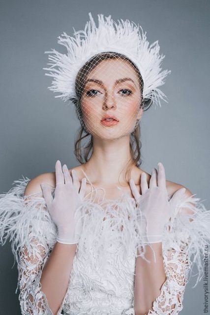 a feather bridal tiara with a birdcage veil will be a nice match for a feathered wedding dress and will bring an edge to your look