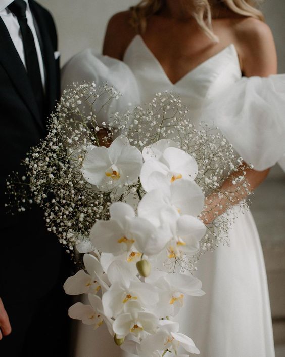 a modern wedding bouquet with baby's breath and orchids is a lovely and cool idea for a modern refined bride