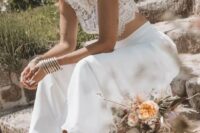 29 a boho western bridal look with a lace crop top, a plain midi skirt, cowboy boots and a neutral hat decorated with dried grass