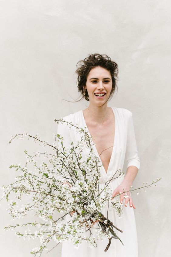 a modern wedding bouquet of white blooming branches is a gorgeous idea for a spring wedding, it looks really fresh