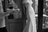 29 an elegant modern off the shoulder wedding dress with a draped bodice and a plain skirt with a train is pure chic