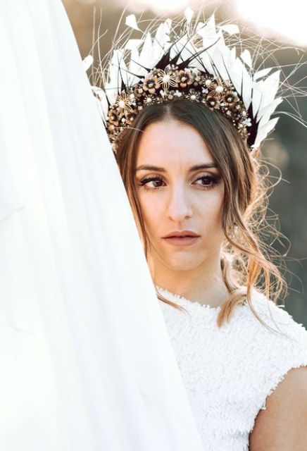 a jaw-dropping bridal tiara with embellishments and flower brooches, feathers and petals is a statement accessory