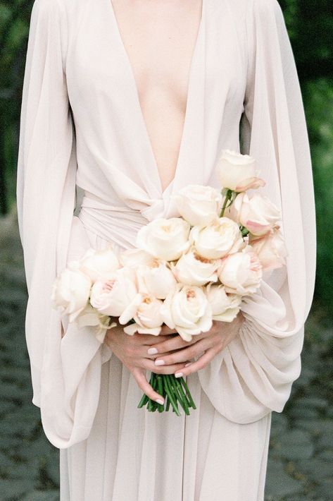 a modern wedding bouquet of peony roses, with a catchy shape is a lovely idea for a modern sophisticated bride