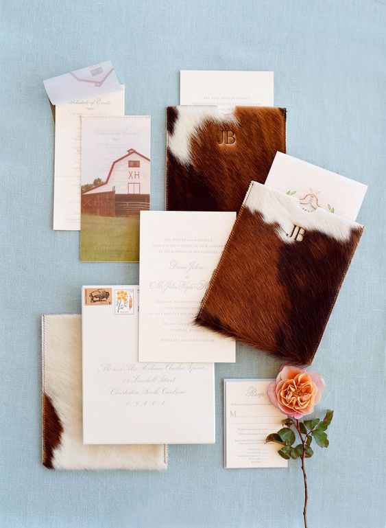 a western wedding invitation suite with cowhide-inspired envelopes, prints cards and calligraphy is very chic and cool