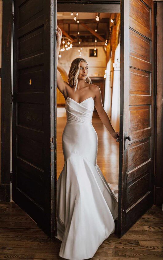 an exquisite modern strapless wedding dress with a mermaid silhouette, a draped bodice and a train is jaw dropping